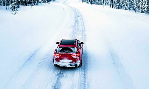 Passenger car on a snowy road to illustrate low-temperature testing