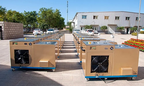 Multiple environmental test systems lined up outside an industrial facility