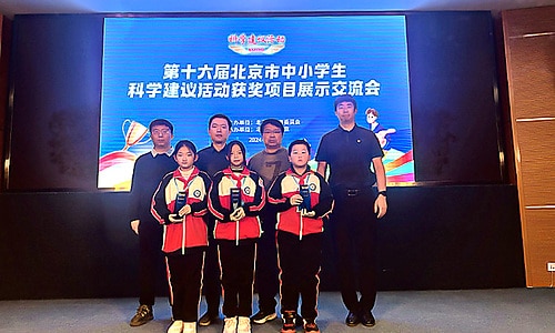 Students and teachers posing together at a science award ceremony