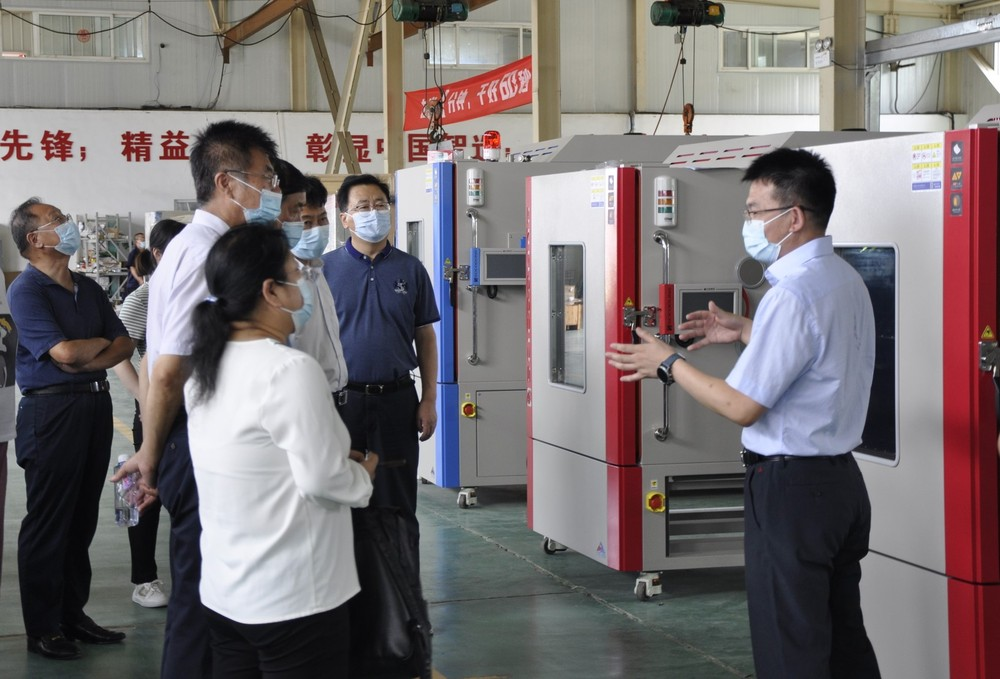 SCICOOLING factory visit with guests learning about environmental testing equipment
