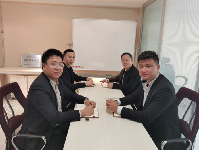 SCICOOLING service center team members discussing work in an office meeting room