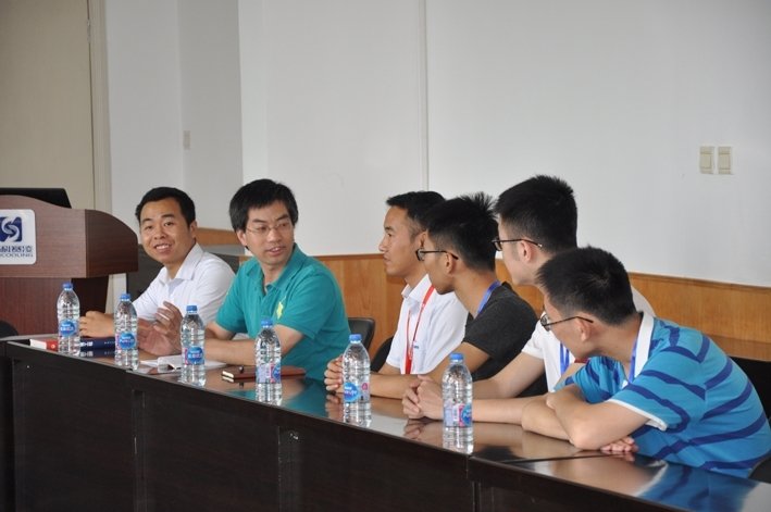 People attending a technical discussion meeting in a conference room.