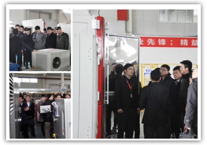 Visitors inspecting SCICOOLING environmental test chambers during a factory tour