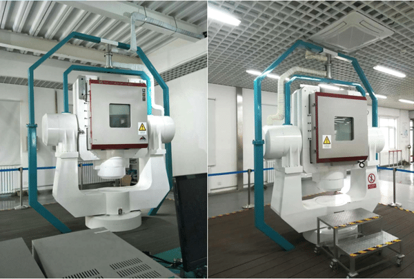 Two rotary-table temperature chambers installed around positioning test rigs