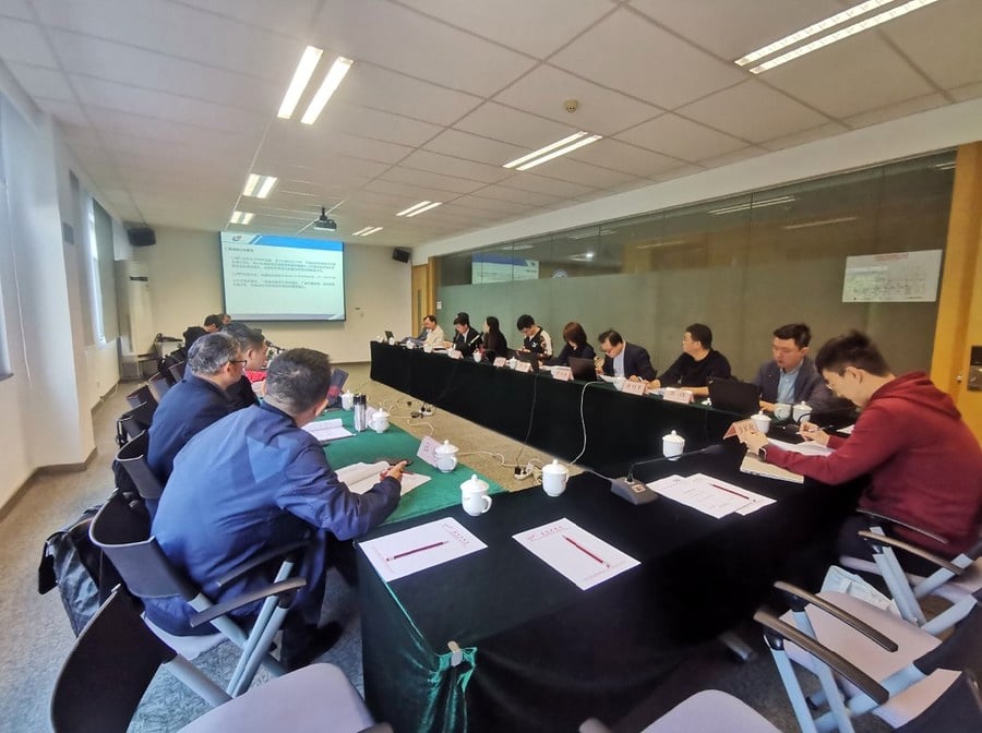 Standards committee members meeting around a conference table