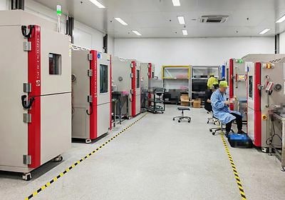 Technician monitoring SCI chambers during factory testing
