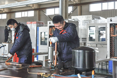 SCI technicians assembling copper refrigeration piping and components