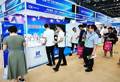 Visitors viewing SCICOOLING equipment at the exhibition booth