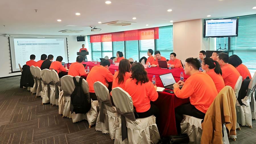 SCICOOLING employees in orange shirts attending the annual sales conference