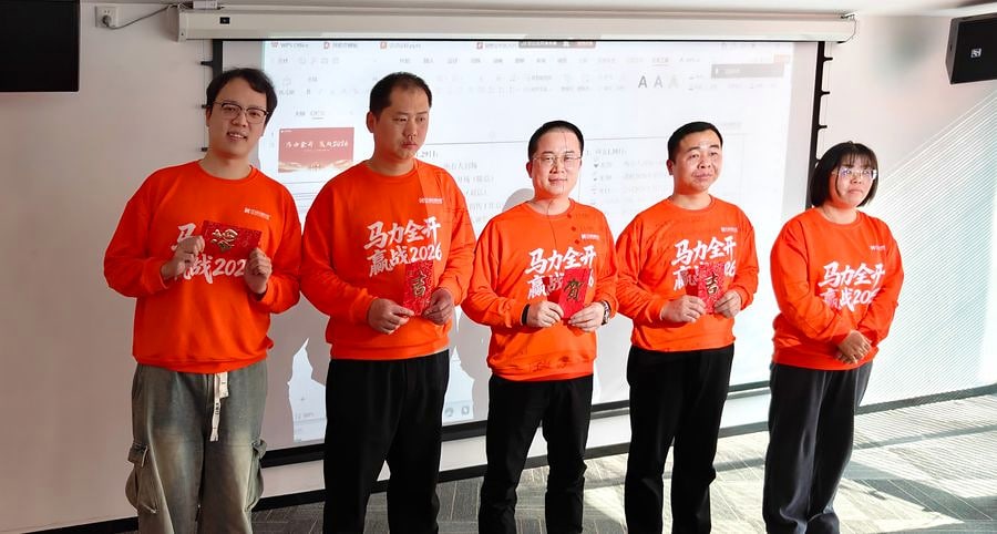 Five SCICOOLING employees standing during a conference recognition session