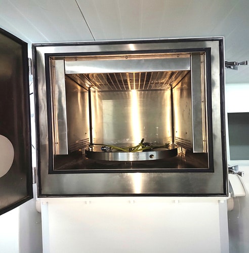 Open stainless steel interior of a rotary table temperature chamber