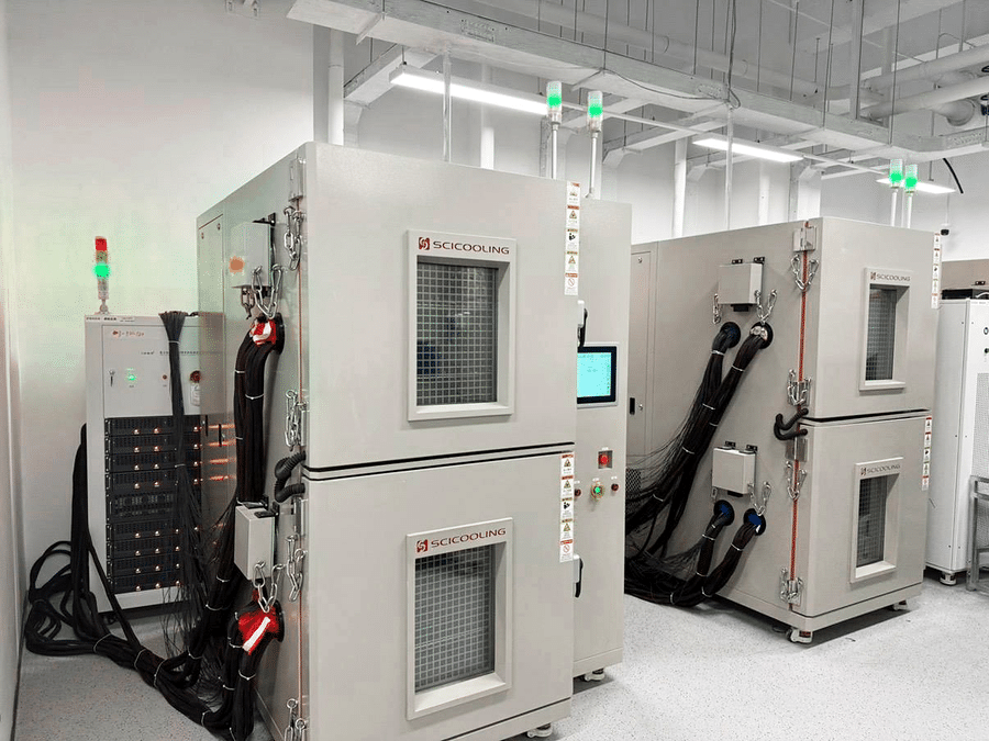 Environmental chambers connected to battery cycling cables and test racks